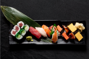 a plate of assorted sushi and sashimi